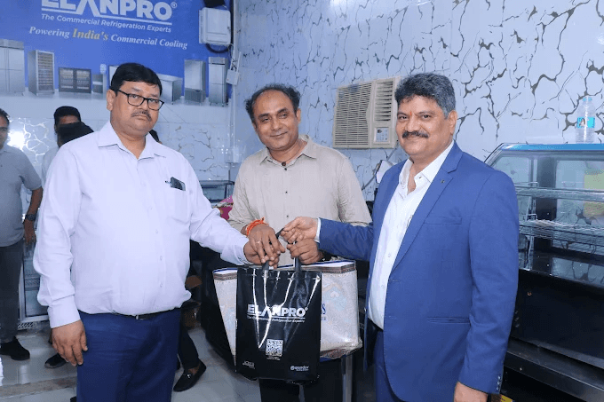 Three visitors together in a kitchen equipment showroom