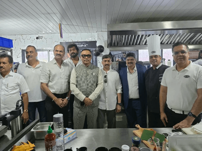 Group with a chef gathered in a commercial kitchen